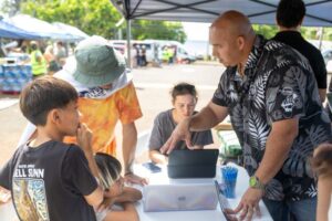 Photo: Keoni Souza speaks with community members