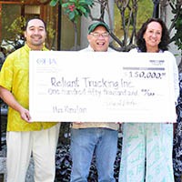 Photo: Reliant Trucking Staff holding a check for $150,000
