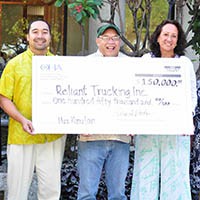 Photo: Reliant Trucking Staff holding a check for $150,000